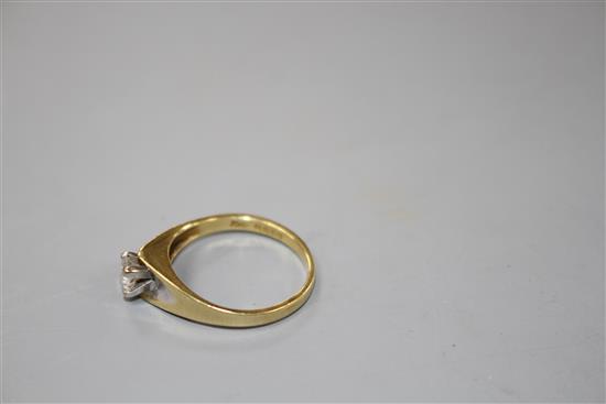 A modern 18ct gold and solitaire diamond ring,